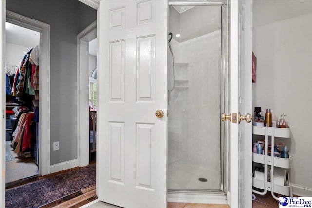 bathroom featuring a shower with door