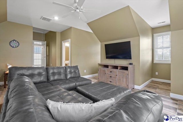 living room featuring hardwood / wood-style flooring, lofted ceiling, and ceiling fan