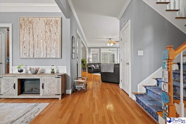 hallway featuring light hardwood / wood-style flooring and ornamental molding