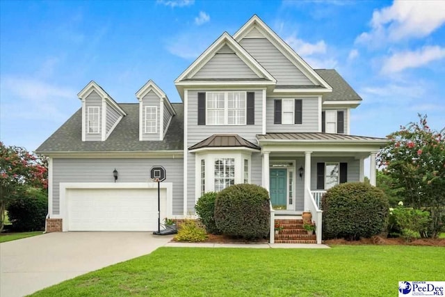 view of front of house with a garage and a front lawn