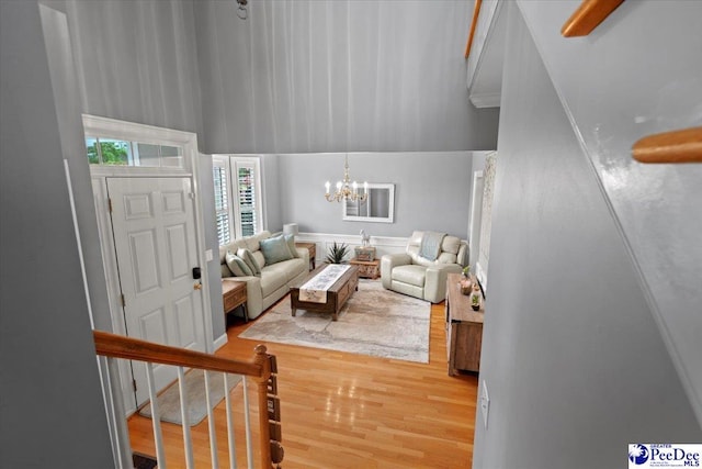 living room with a chandelier and light wood-type flooring