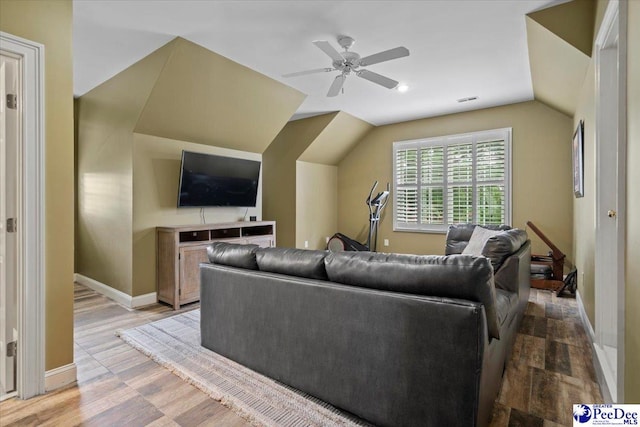 living room with lofted ceiling, hardwood / wood-style flooring, and ceiling fan