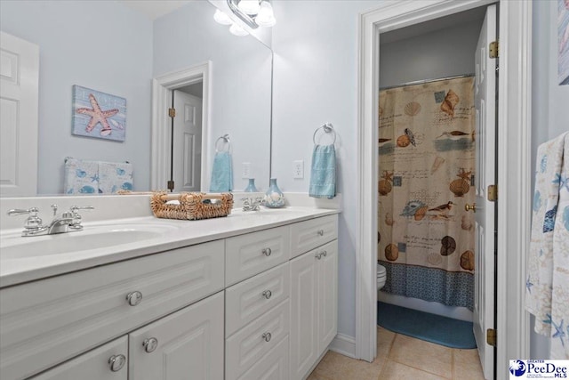 bathroom with a shower with curtain, vanity, toilet, and tile patterned flooring