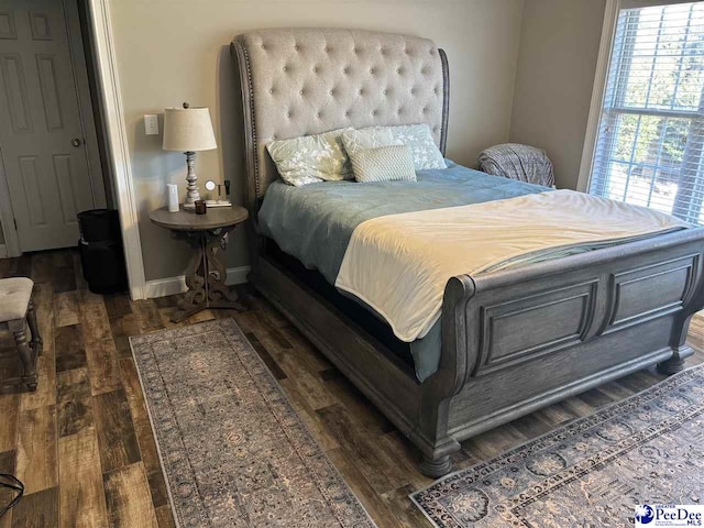 bedroom with dark wood-type flooring