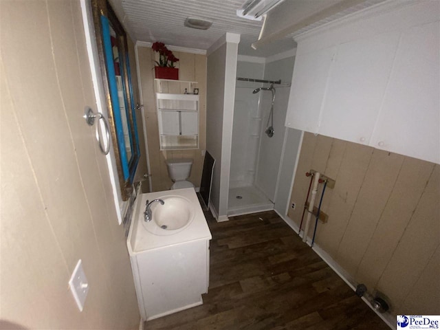 bathroom featuring crown molding, wood-type flooring, toilet, and walk in shower