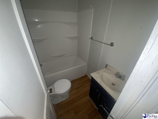 full bathroom featuring vanity, hardwood / wood-style floors,  shower combination, and toilet