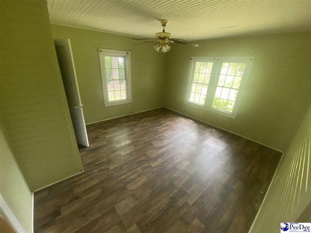 unfurnished room featuring dark hardwood / wood-style floors and ceiling fan