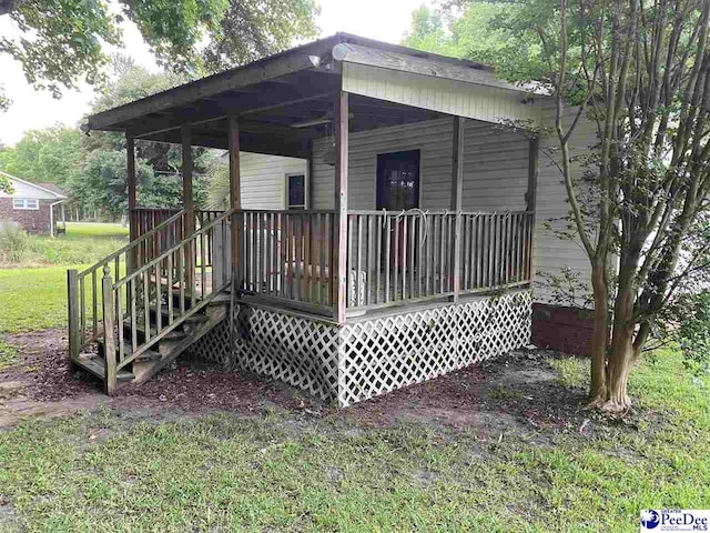 wooden terrace with a yard