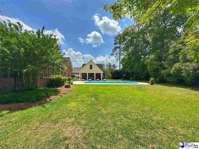 swimming pool featuring a patio and a sunroom