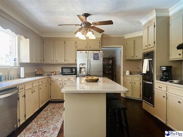 1217 Hillside Dr, Dillon, SC 29536 - kitchen featuring black appliances, cream cabinetry, a sink, a textured ceiling, and crown molding