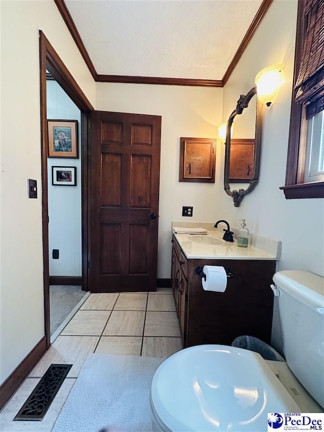 1217 Hillside Dr, Dillon, SC 29536 - bathroom featuring baseboards, crown molding, toilet, and vanity