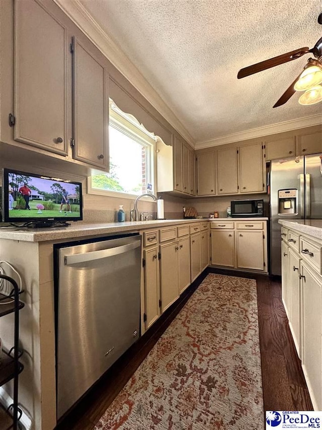 1217 Hillside Dr, Dillon, SC 29536 - kitchen featuring appliances with stainless steel finishes, a textured ceiling, ceiling fan, dark wood-style flooring, and crown molding