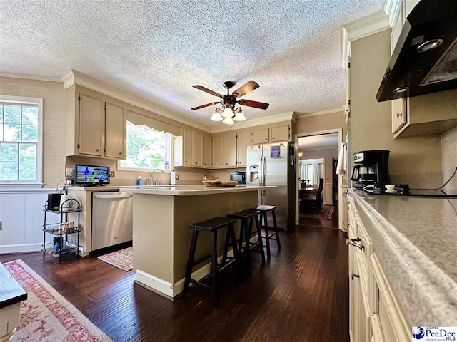 1217 Hillside Dr, Dillon, SC 29536 - kitchen featuring appliances with stainless steel finishes, range hood, ornamental molding, light countertops, and dark wood-style floors
