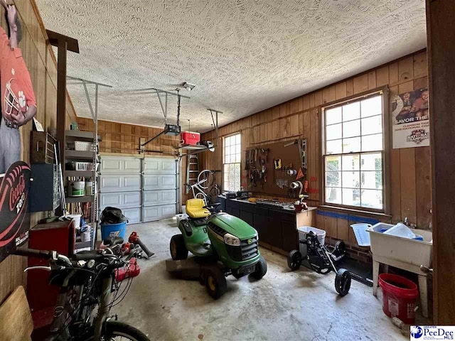 garage with wooden walls and a garage door opener