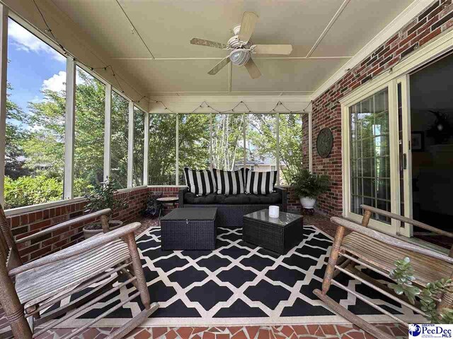 1217 Hillside Dr, Dillon, SC 29536 - sunroom with an outdoor living space, ceiling fan, and plenty of natural light