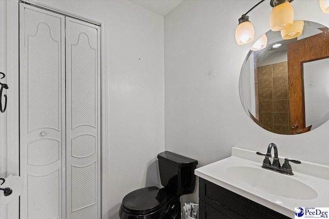 bathroom featuring vanity and toilet