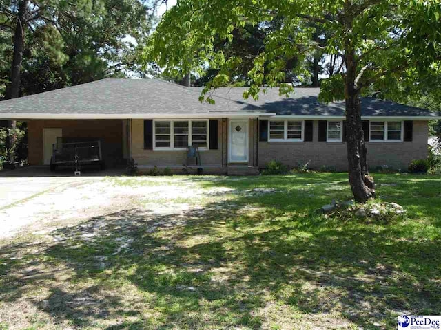 single story home featuring a carport and a front lawn