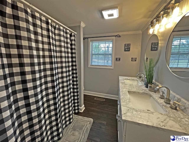 bathroom featuring vanity, wood-type flooring, and ornamental molding