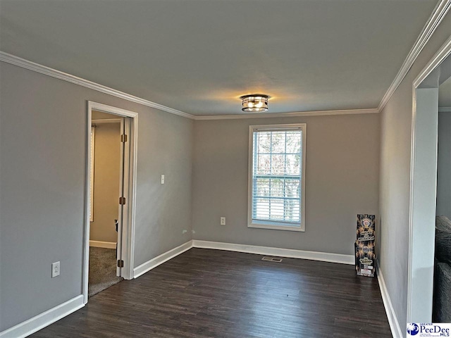 empty room with ornamental molding and dark hardwood / wood-style floors