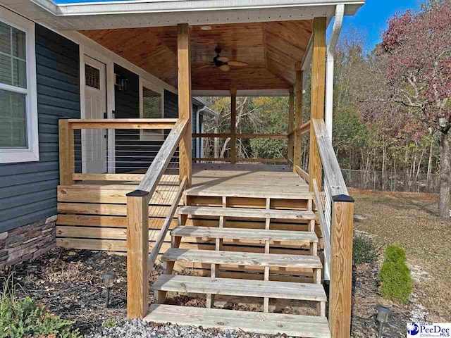 wooden deck featuring ceiling fan