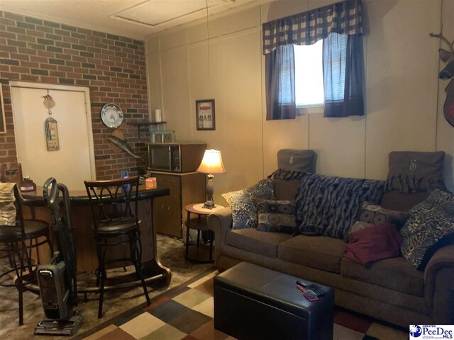 living room with brick wall