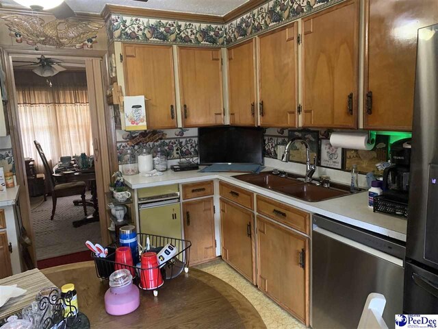 kitchen with crown molding, ceiling fan, appliances with stainless steel finishes, and sink