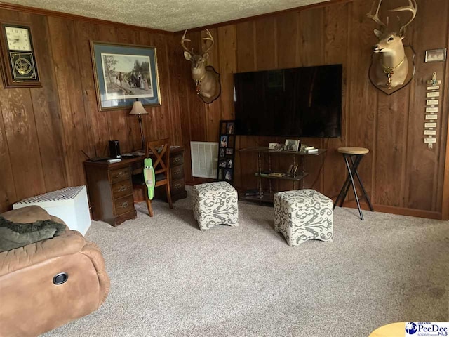 living room featuring carpet floors, wooden walls, and a textured ceiling