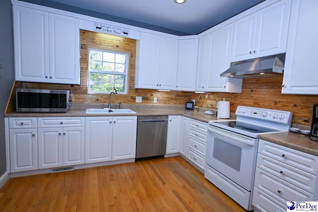 kitchen featuring white cabinetry, sink, light hardwood / wood-style flooring, and stainless steel appliances