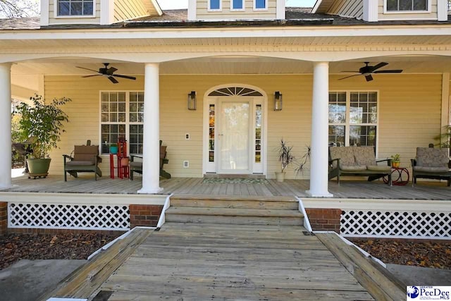 entrance to property with a porch and ceiling fan