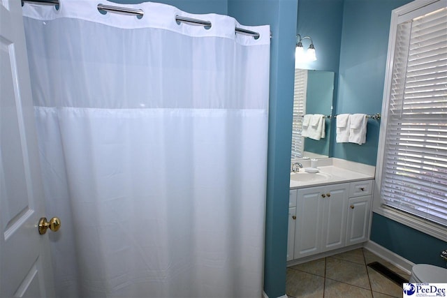 bathroom featuring tile patterned flooring and vanity