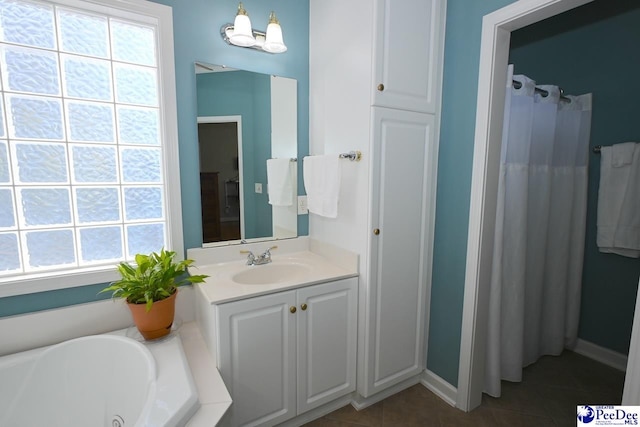 bathroom featuring vanity, tile patterned flooring, and a bathtub