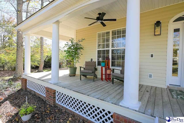 deck with ceiling fan and covered porch