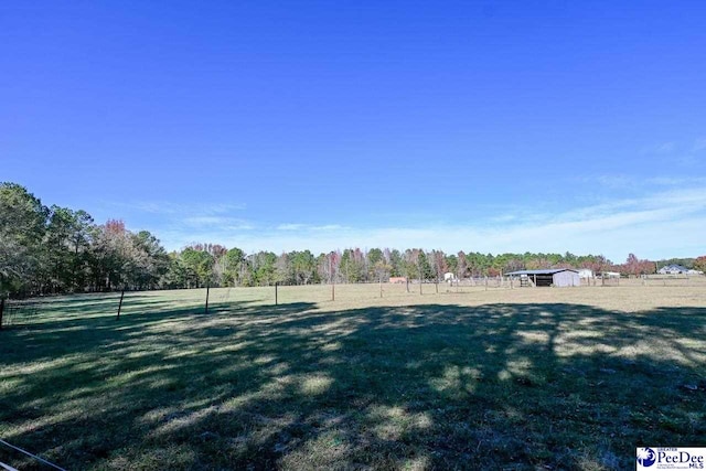 view of yard with a rural view