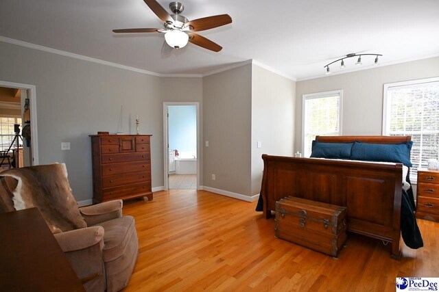 bedroom with connected bathroom, crown molding, and light hardwood / wood-style flooring