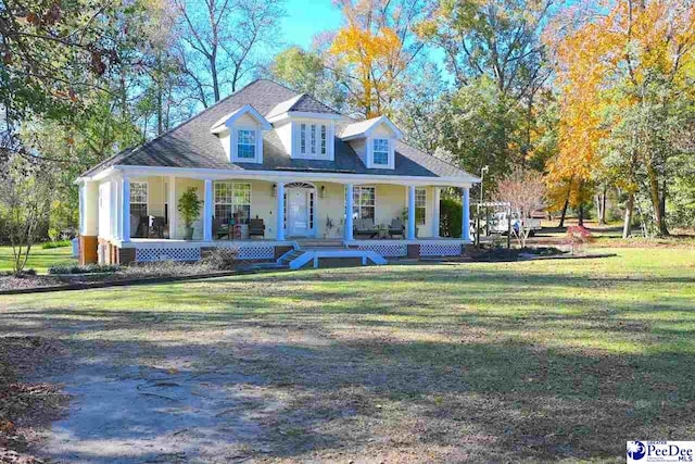 view of front of property featuring covered porch and a front yard