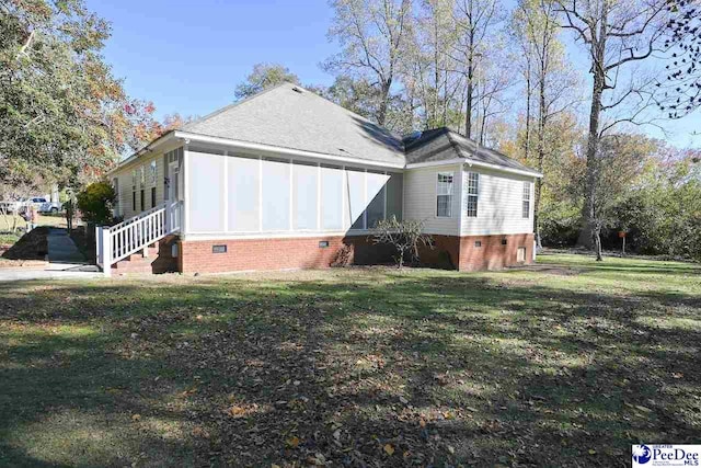 view of side of home with a lawn