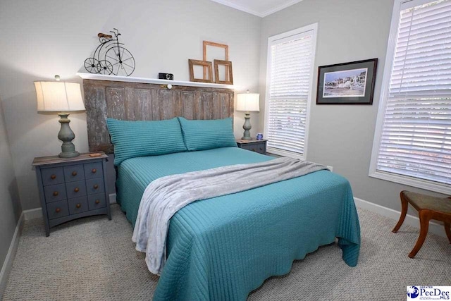 bedroom with ornamental molding and light carpet