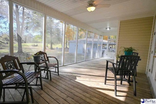 sunroom / solarium featuring ceiling fan