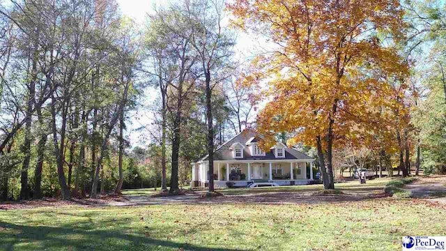 view of front of house with a front yard and covered porch