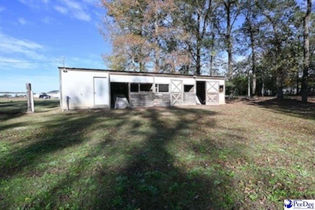 view of outbuilding with a yard