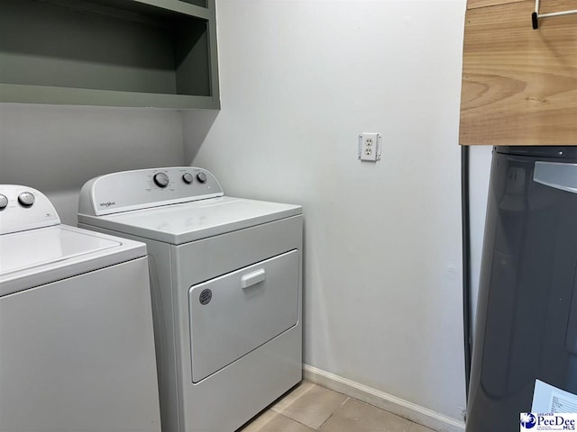 918 Fore Rd, Florence, SC 29506 - washroom with washing machine and dryer, laundry area, light tile patterned flooring, and baseboards