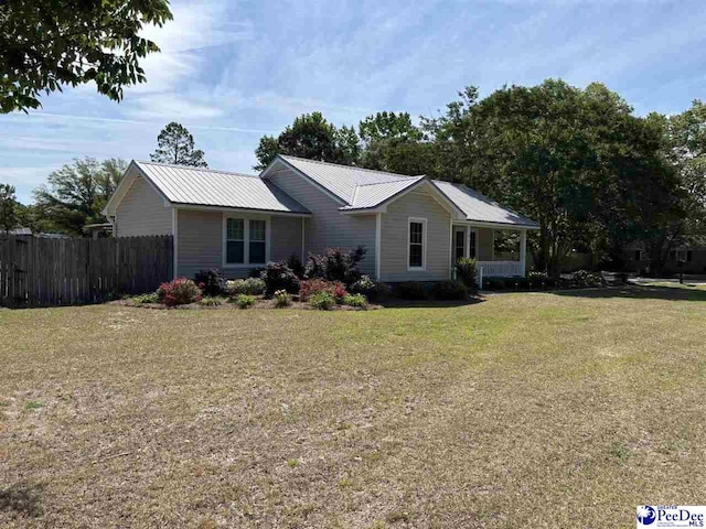 918 Fore Rd, Florence, SC 29506 - ranch-style house with metal roof, fence, and a front lawn