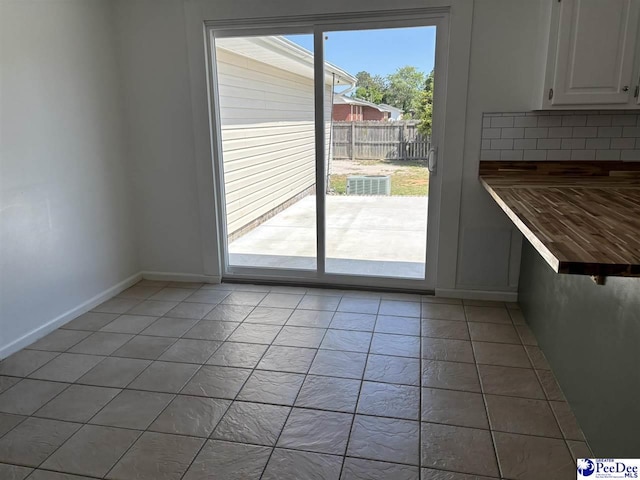 918 Fore Rd, Florence, SC 29506 - unfurnished dining area featuring baseboards and light tile patterned floors