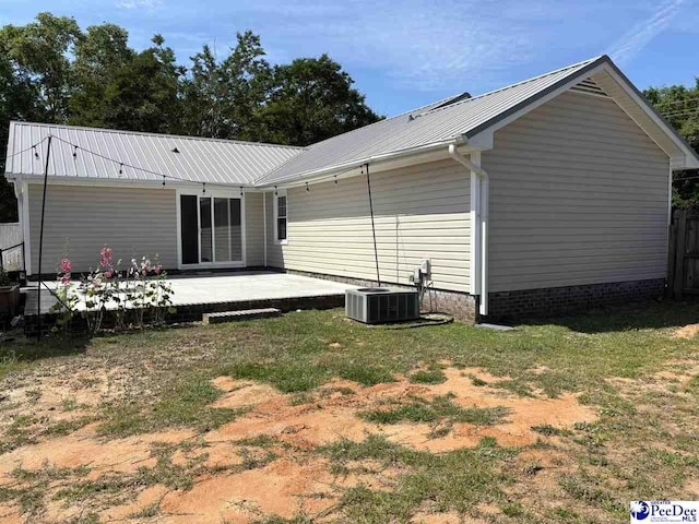 918 Fore Rd, Florence, SC 29506 - back of house featuring central air condition unit, a patio area, metal roof, and a yard