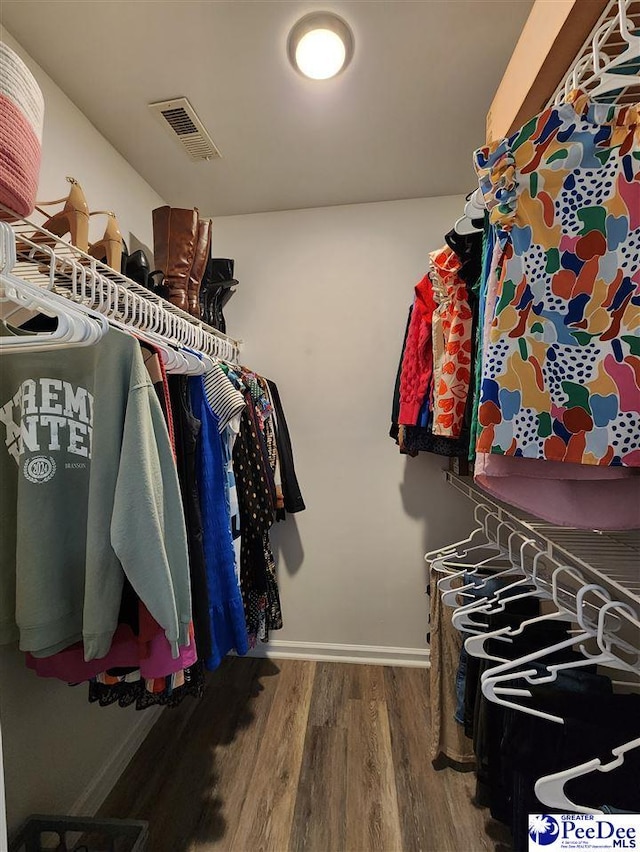 walk in closet featuring wood finished floors and visible vents