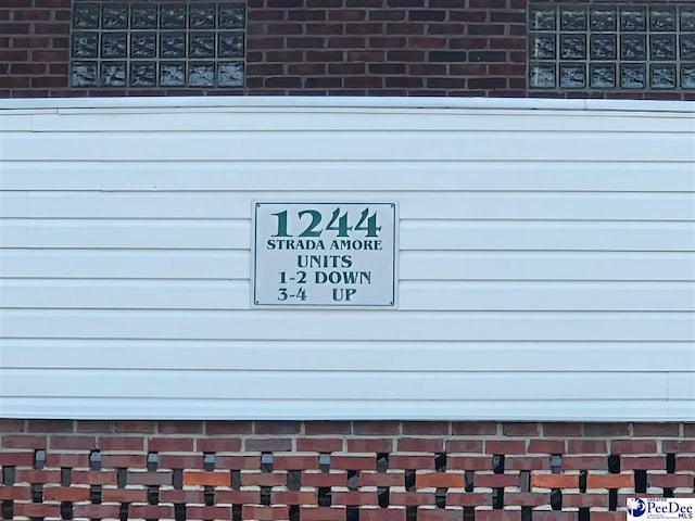 exterior details featuring brick siding