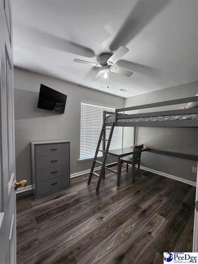 unfurnished bedroom with dark wood finished floors and baseboards