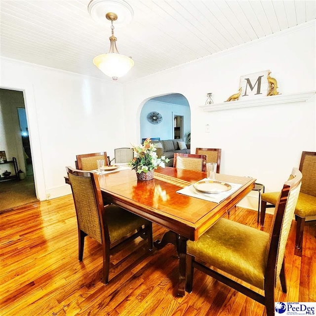 dining space with crown molding, wood ceiling, and light hardwood / wood-style floors