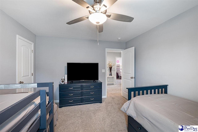 bedroom featuring light carpet, ceiling fan, and baseboards