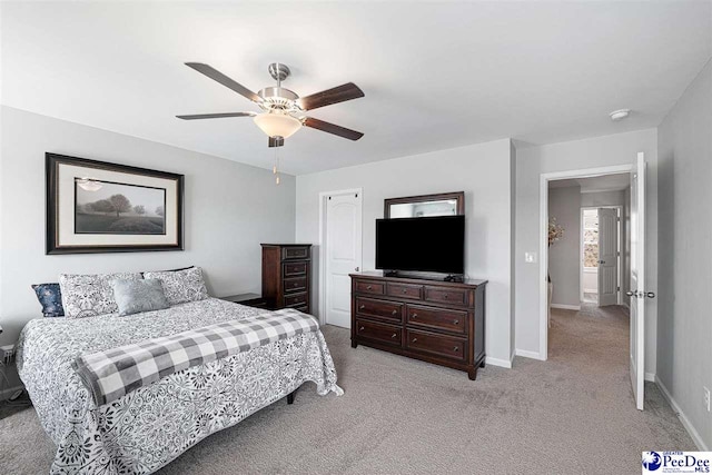 bedroom with light carpet, a ceiling fan, and baseboards